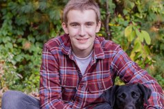 Yearbook photos at home in the fall. A boy with his dog. Class o