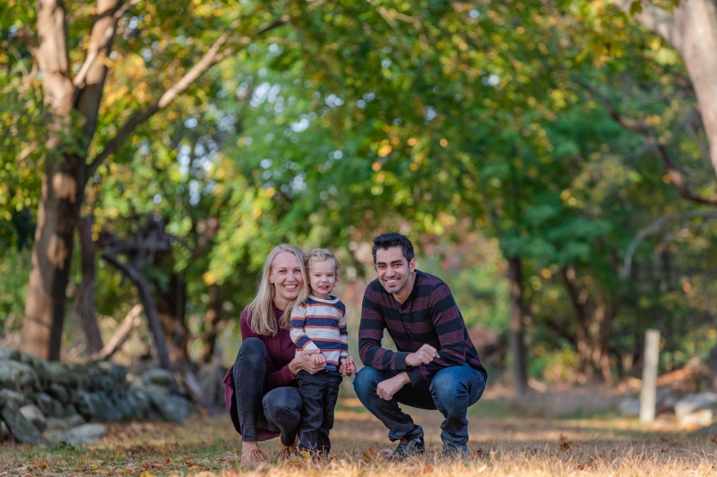 Mom , Dad and toddler son enjoy the scenery on a crisp fall monr