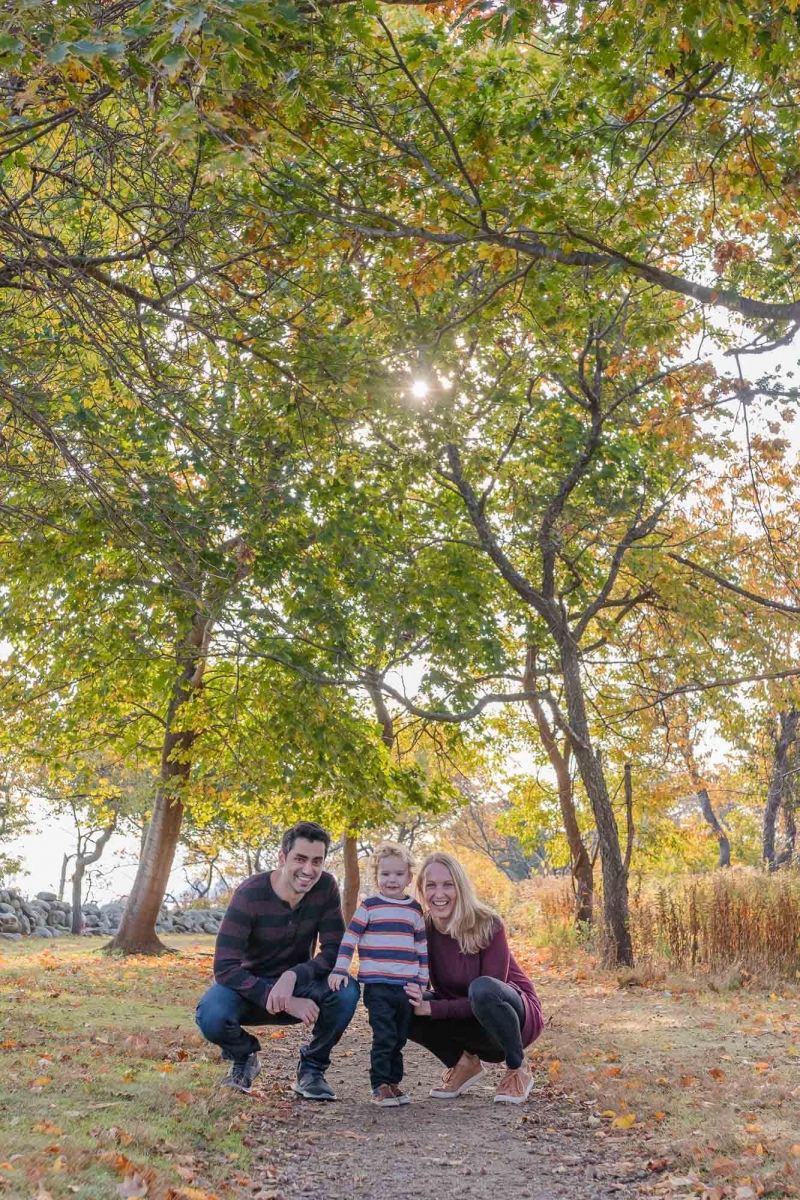 Mom , Dad and toddler son enjoy the scenery on a crisp fall monr