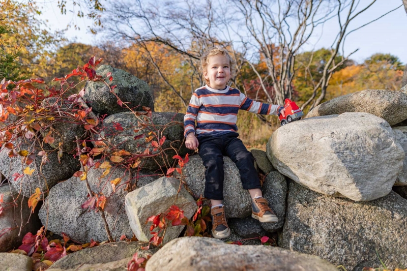 Mom , Dad and toddler son enjoy the scenery on a crisp fall monr
