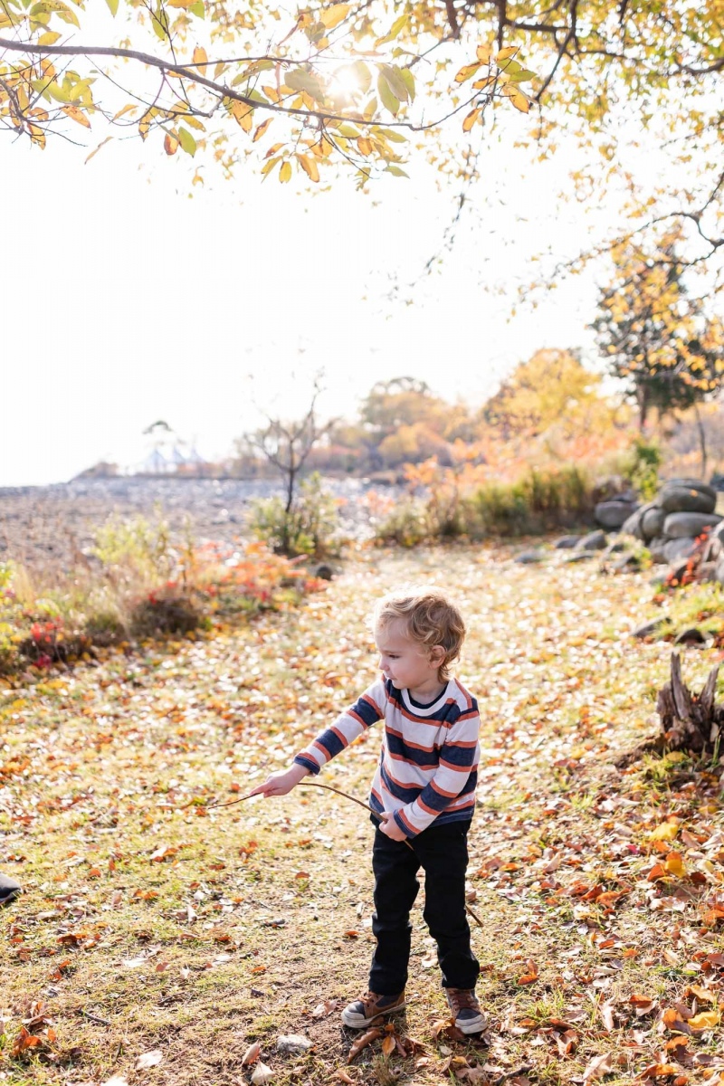 Mom , Dad and toddler son enjoy the scenery on a crisp fall monr