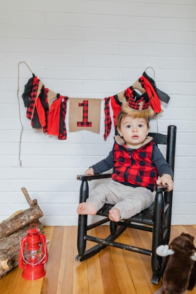 Baby Brother's First Birthday - Camp themed first birthday session - moose rocking chair - black and red plaid - big sister with pink bow