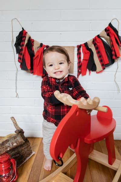 Baby Brother's First Birthday - Camp themed first birthday session - moose rocking chair - black and red plaid - big sister with pink bow