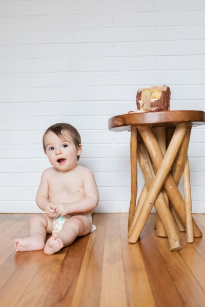 Baby Brother's First Birthday - Camp themed first birthday session - moose rocking chair - black and red plaid - big sister with pink bow